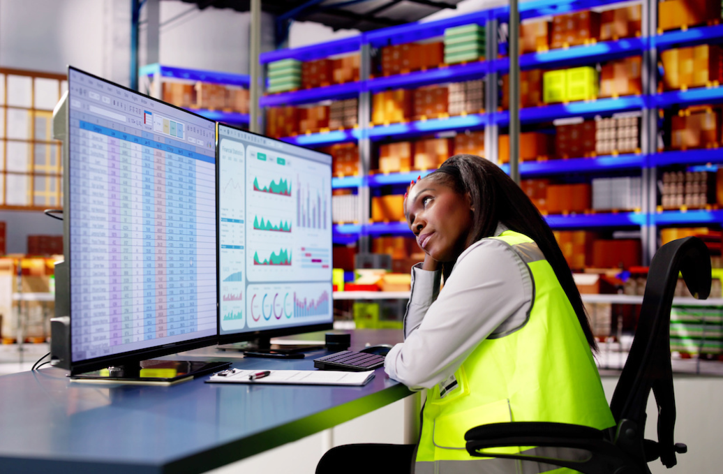 Stressed worker looking frustrated while checking on a late shipment